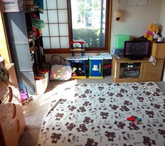 チェストやテレビ、3段ボックスなどにおもちゃなどが設置されている井上福祉員保育室の室内の写真