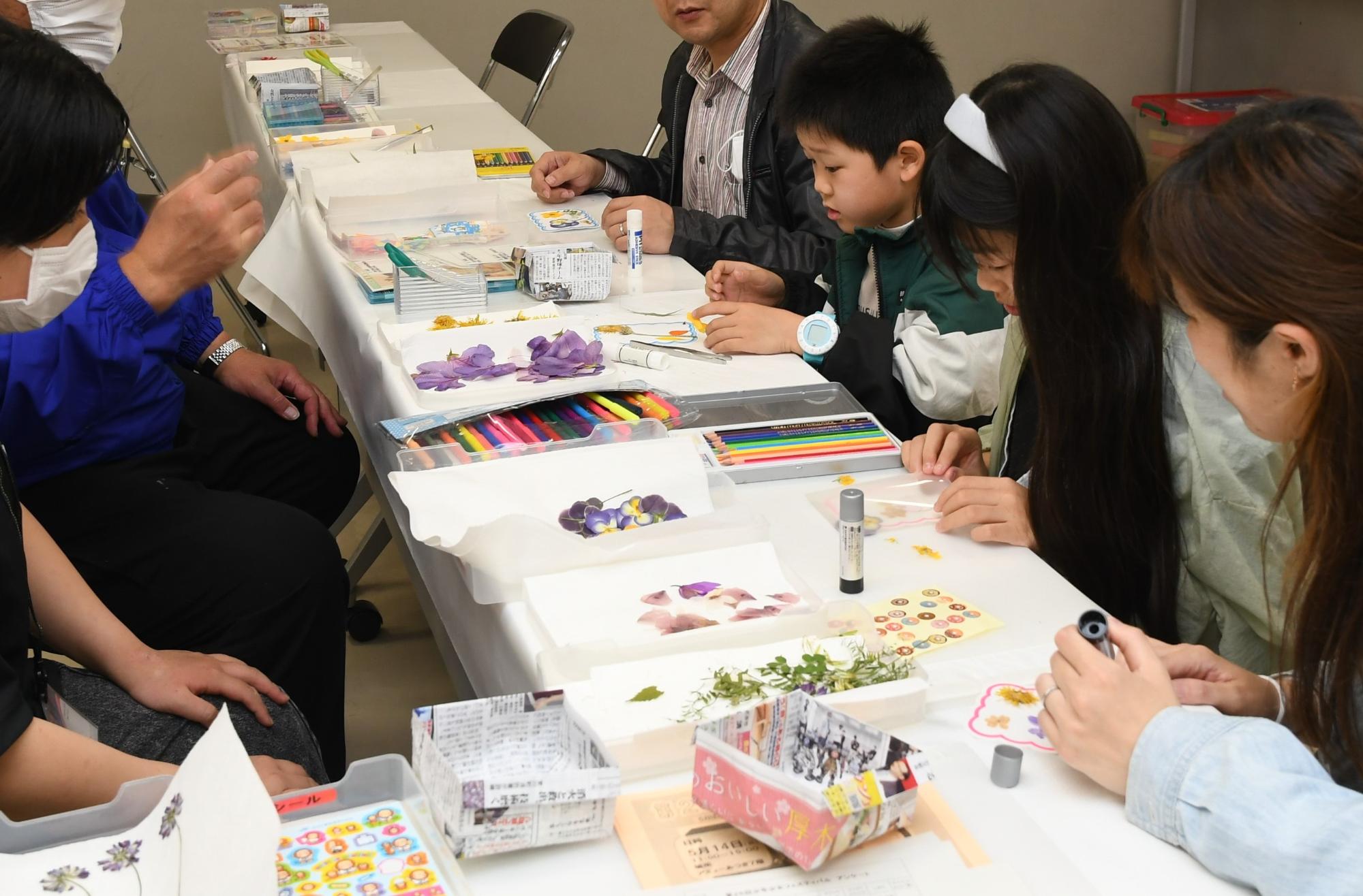 少年少女フェスティバルでオリジナルデザインのしおりつくる親子