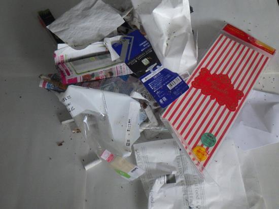 煙草の箱、吸い殻、サンドイッチの包み紙などのごみの写真