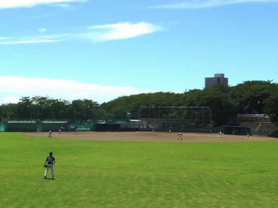 青空の下、厚木野球場で野球が行われている写真