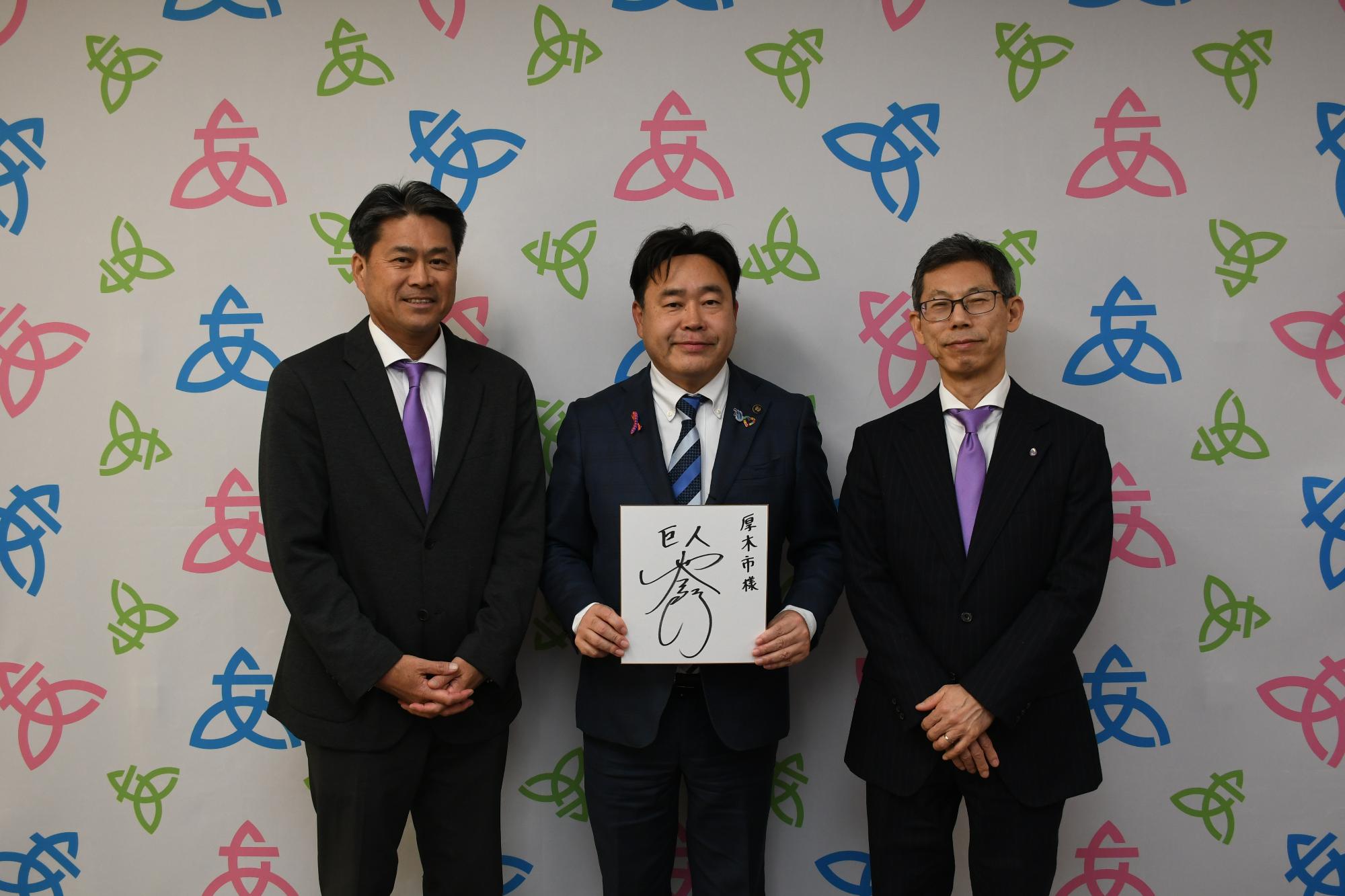 読売ジャイアンツに育成1位で指名された冨重投手のサインを持った記念写真