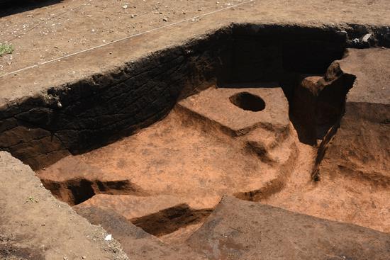 茶色い土の中に竪穴住居跡の丸い穴があいている写真
